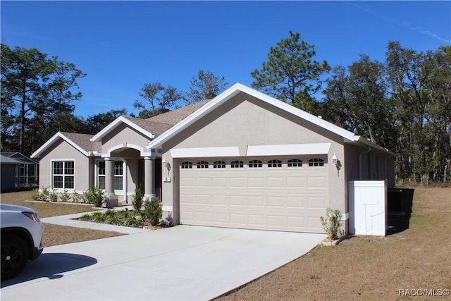 single story home featuring a garage and a front yard