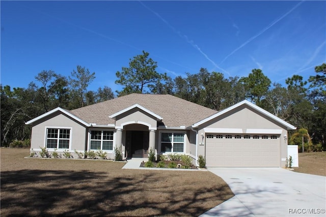 single story home with a garage and a front lawn