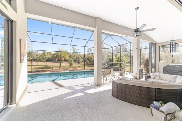 unfurnished sunroom featuring ceiling fan, vaulted ceiling, and a swimming pool