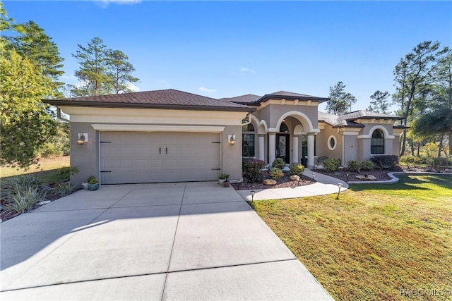 mediterranean / spanish-style home with a garage and a front yard