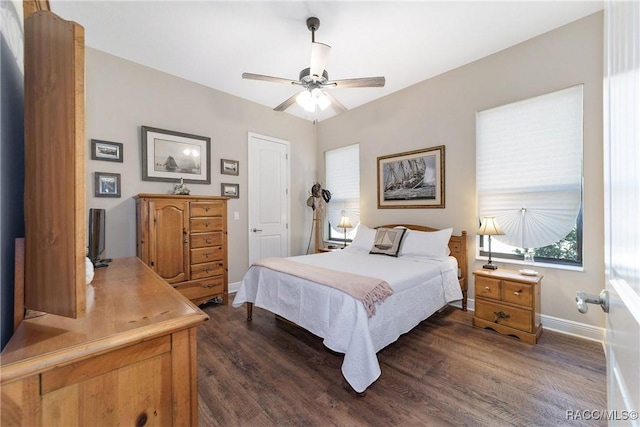 bedroom with dark hardwood / wood-style floors and ceiling fan