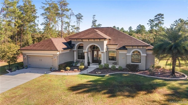 mediterranean / spanish-style home featuring a garage and a front yard