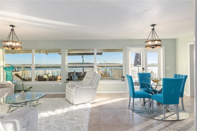 interior space with a water view and plenty of natural light