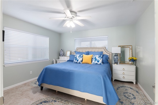 bedroom with ceiling fan and light tile patterned floors