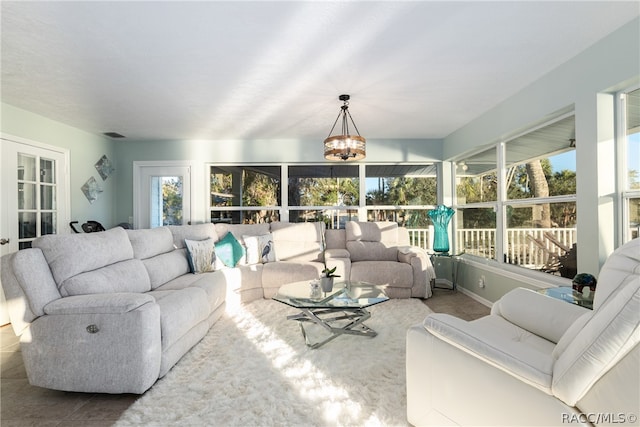 living room featuring tile patterned floors and a notable chandelier