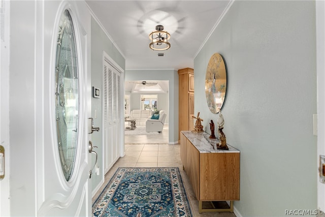 corridor with light tile patterned floors and crown molding