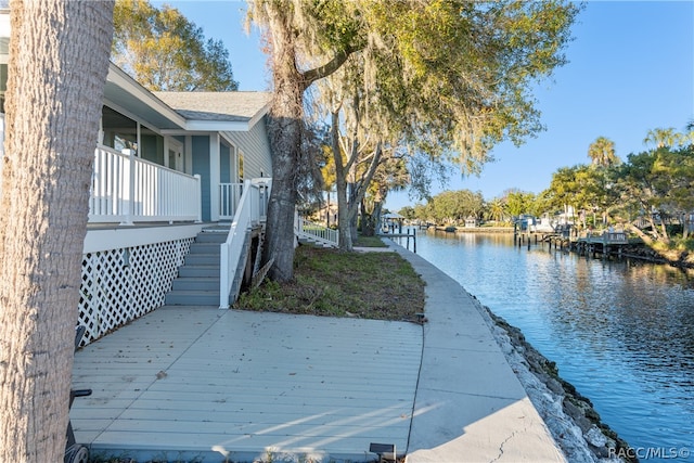 exterior space featuring a deck with water view