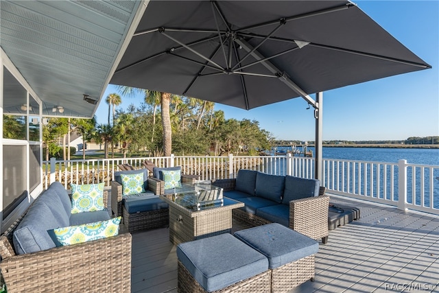 wooden terrace featuring an outdoor hangout area and a water view