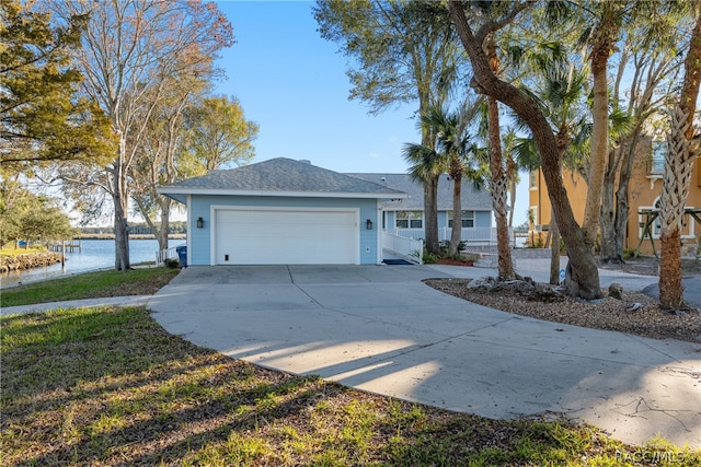 ranch-style home with a water view and a garage