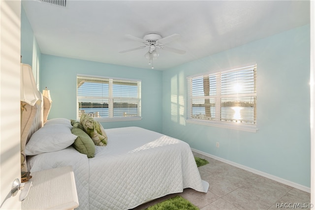 tiled bedroom with ceiling fan