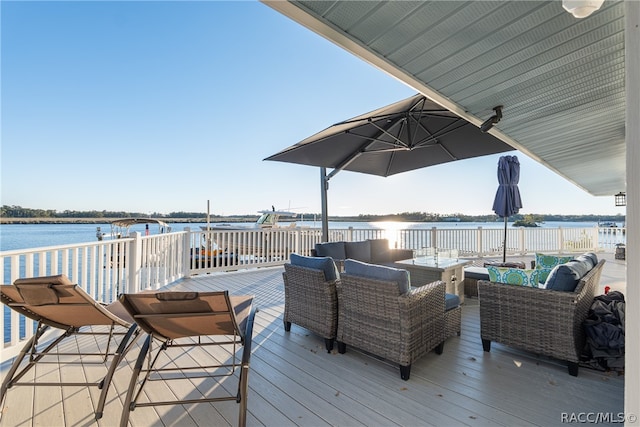 wooden deck with a water view and an outdoor hangout area