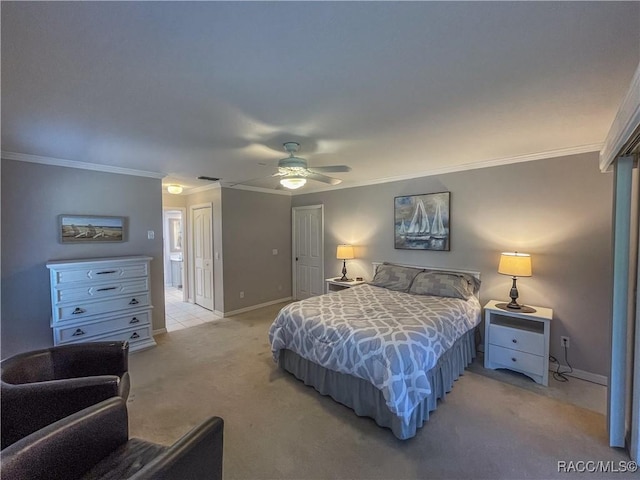 bedroom featuring ceiling fan, connected bathroom, light carpet, baseboards, and ornamental molding