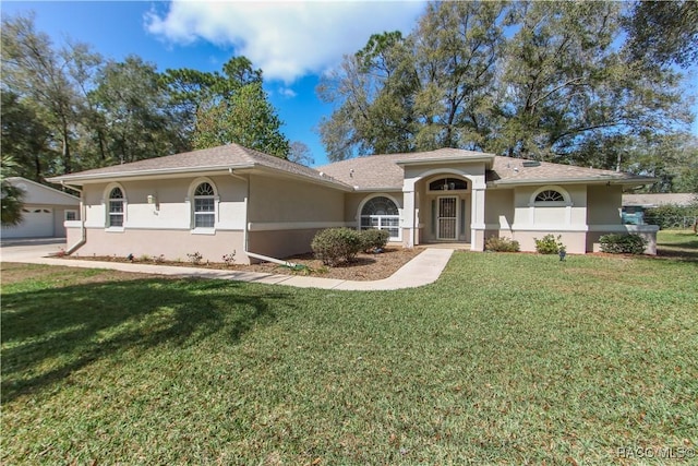 view of front of house featuring a front lawn and stucco siding