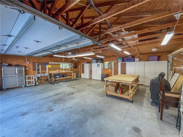 garage with a workshop area and a garage door opener