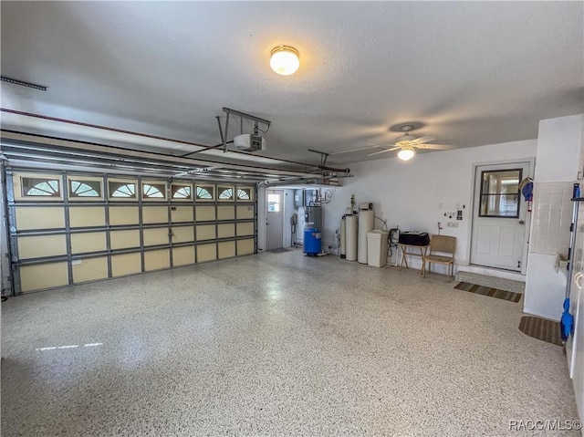 garage with ceiling fan, water heater, and a garage door opener