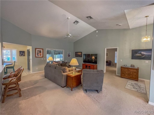 living room featuring high vaulted ceiling, visible vents, light carpet, and ceiling fan with notable chandelier