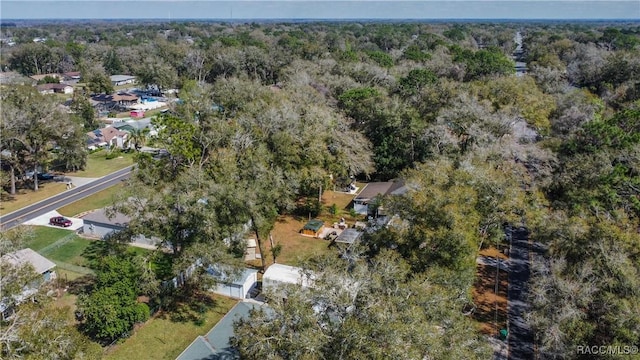 drone / aerial view featuring a residential view and a view of trees