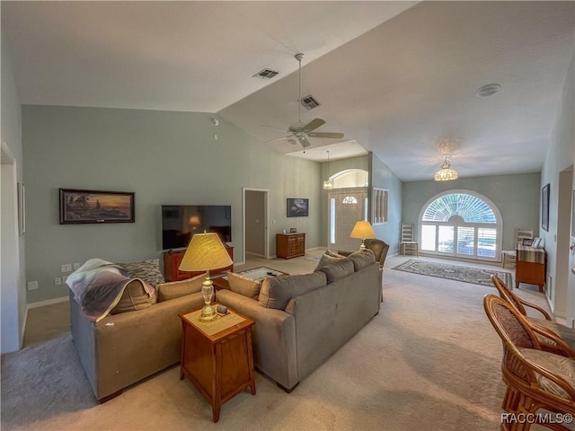 living room featuring lofted ceiling, a ceiling fan, visible vents, and light colored carpet