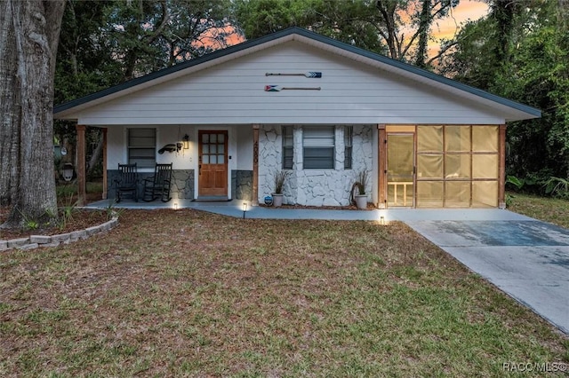 4080 N Eagle Nest Pt, Crystal River, FL 34428 - view of front of property with stone siding, covered porch, and a lawn