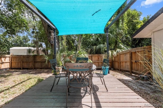 4080 N Eagle Nest Pt, Crystal River, FL 34428 - wooden deck featuring outdoor dining space and a fenced backyard