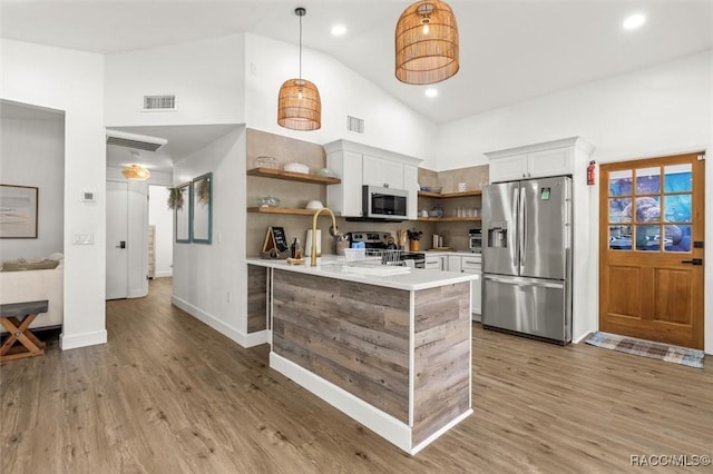 4080 N Eagle Nest Pt, Crystal River, FL 34428 - kitchen featuring open shelves, appliances with stainless steel finishes, light countertops, white cabinetry, and high vaulted ceiling