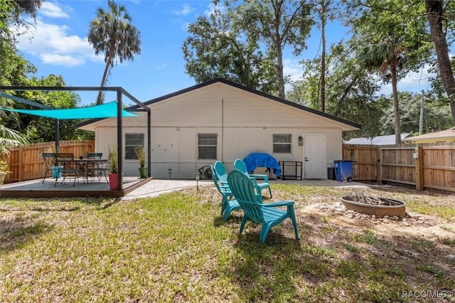 4080 N Eagle Nest Pt, Crystal River, FL 34428 - back of property with a fire pit, a fenced backyard, and a patio area