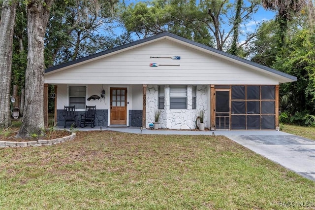 4080 N Eagle Nest Pt, Crystal River, FL 34428 - view of front of property with stone siding, a front yard, and a porch