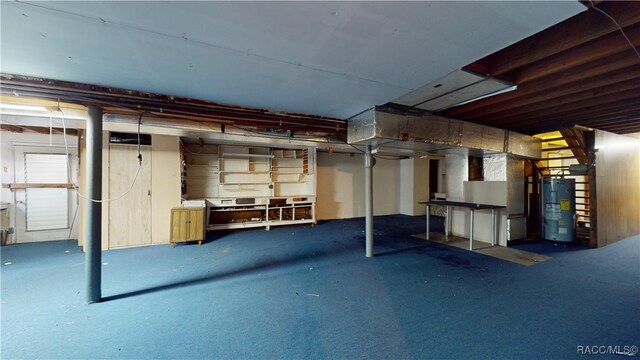 basement with water heater and carpet