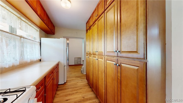 kitchen featuring white appliances and light hardwood / wood-style floors