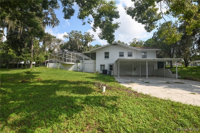 rear view of house with cooling unit and a lawn