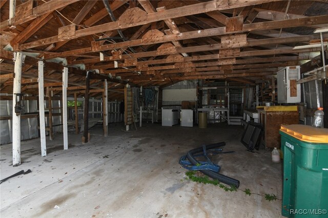 misc room featuring electric panel and vaulted ceiling