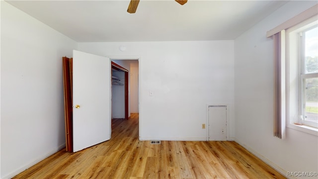 empty room with ceiling fan and light wood-type flooring