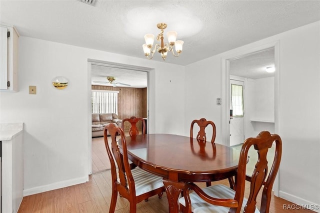 2 James St, Beverly Hills, FL 34465 - dining area with light wood-style floors, a chandelier, a textured ceiling, and ceiling fan