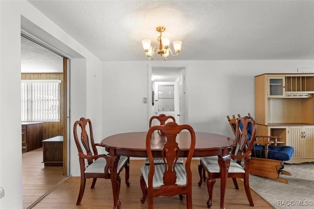 2 James St, Beverly Hills, FL 34465 - dining room featuring a chandelier, light wood-style floors, and a textured ceiling