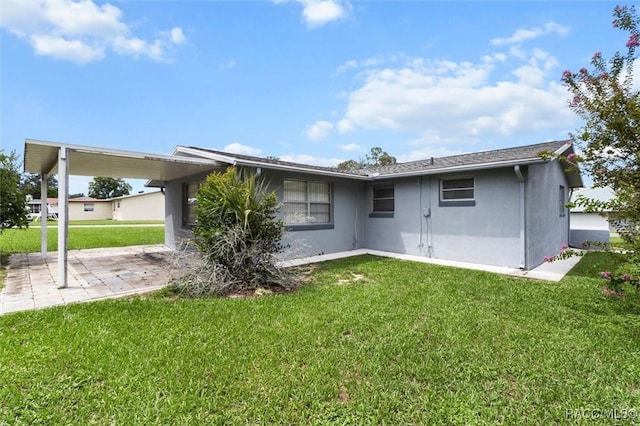 2 James St, Beverly Hills, FL 34465 - back of house featuring a yard, stucco siding, and a patio area
