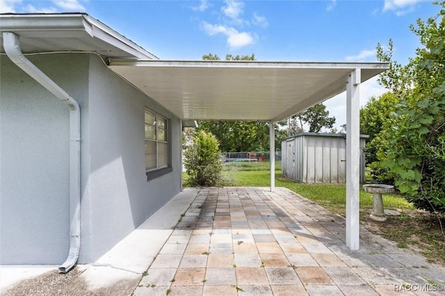 2 James St, Beverly Hills, FL 34465 - view of patio with a storage unit and a carport