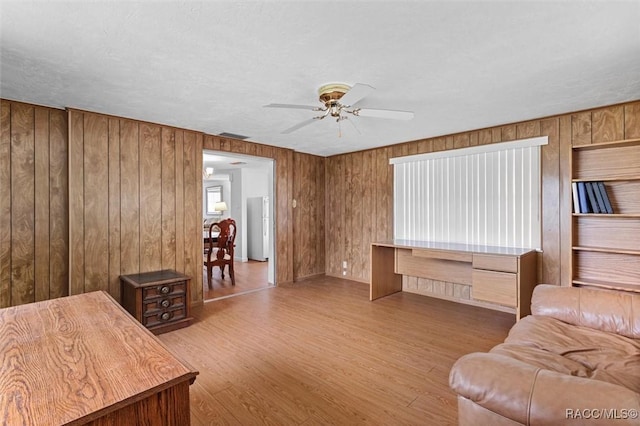 2 James St, Beverly Hills, FL 34465 - living area featuring ceiling fan, wooden walls, and wood finished floors