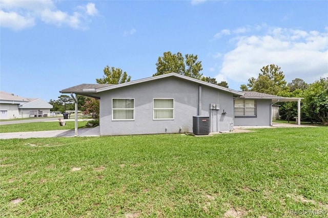 2 James St, Beverly Hills, FL 34465 - rear view of house featuring stucco siding and a yard
