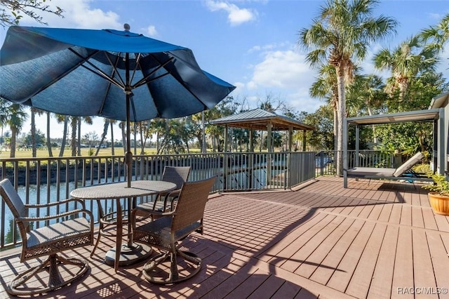 wooden deck featuring a gazebo and a water view