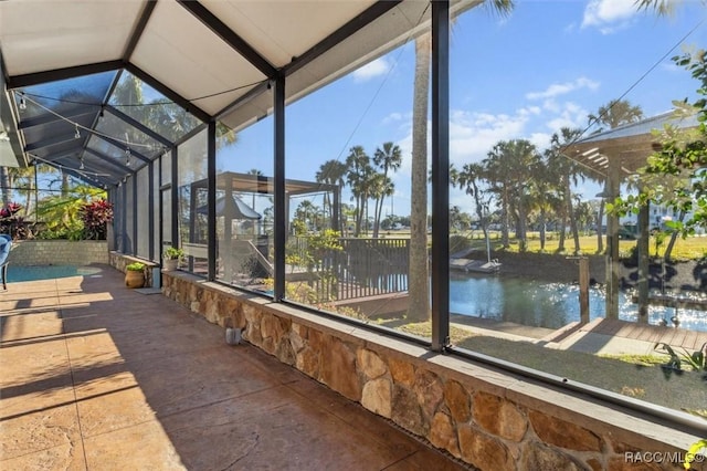 unfurnished sunroom with a water view and lofted ceiling