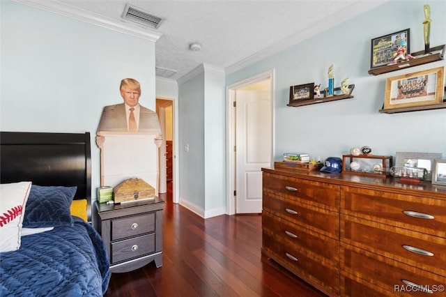 bedroom featuring crown molding and dark hardwood / wood-style floors