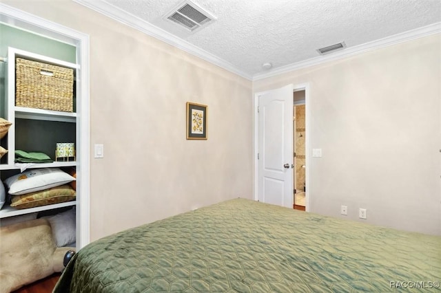 bedroom featuring crown molding and a textured ceiling