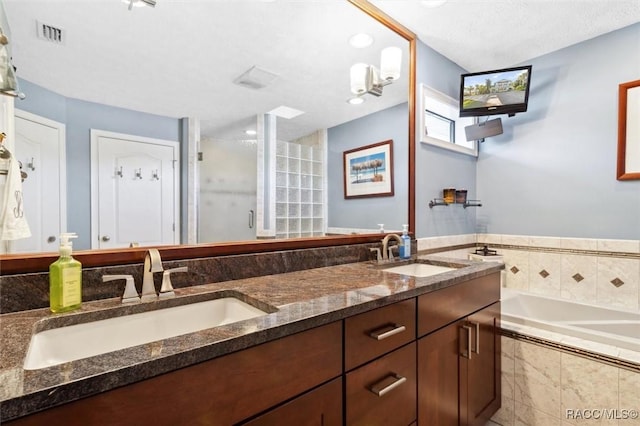 bathroom featuring separate shower and tub and vanity