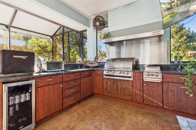 view of patio featuring an outdoor kitchen, a grill, and beverage cooler