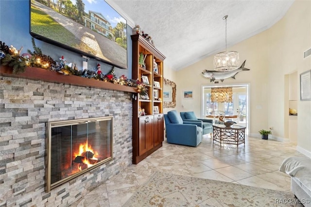 living room featuring a textured ceiling, vaulted ceiling, a fireplace, and a chandelier