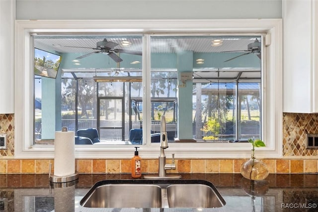 kitchen with tasteful backsplash and dark stone countertops