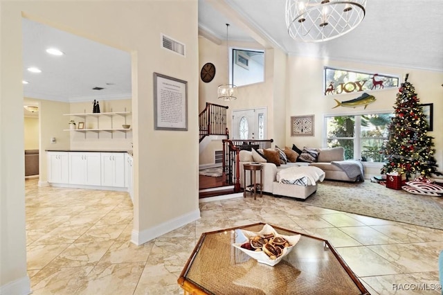 living room with a notable chandelier and ornamental molding