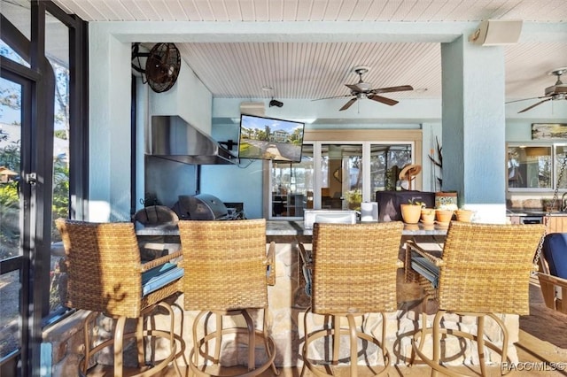 dining room with beamed ceiling and a wall of windows