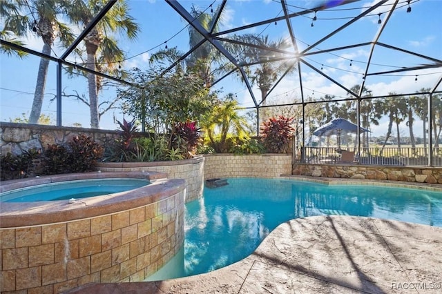 view of pool featuring an in ground hot tub and a lanai