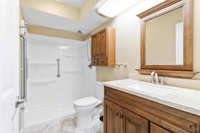 bathroom featuring vanity, toilet, and walk in shower